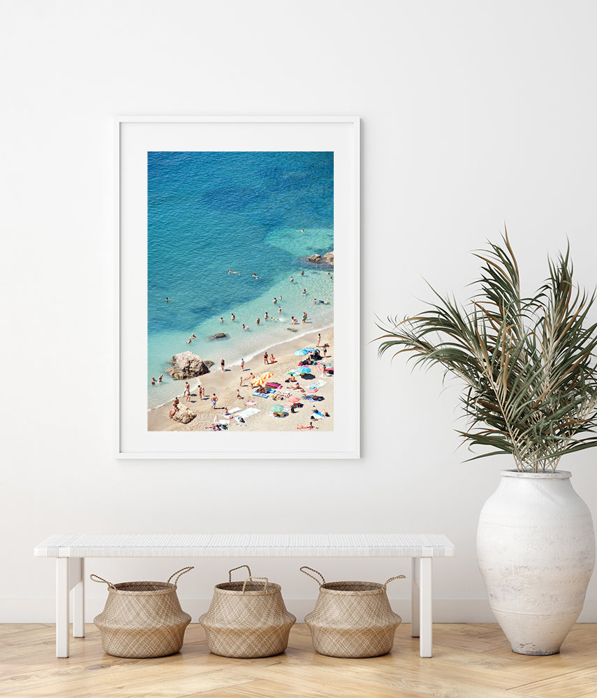 French Riviera beach print featuring the cote d'azur beach of villefranche sur mer on a summer day showing the colourful beach umbrellas and the beach goers enjoying the sun and sea by photographer Millie Brown