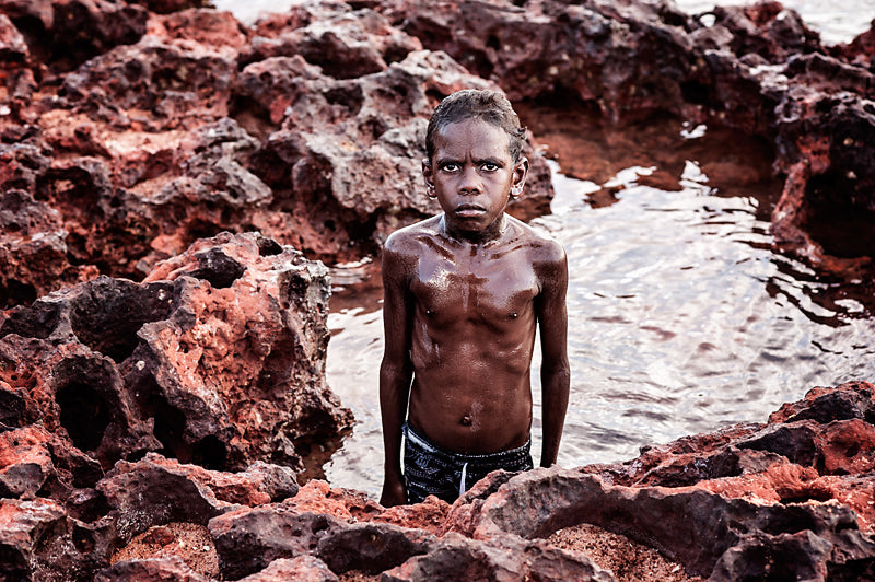A Moment Millie Brown's finalist National Photographic Portrait Prize 2017 image of Yolngu boy Peter Brown in a rock pool at Nyinyikay homeland in East Arnhem Land