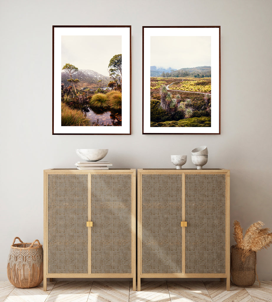 Cradle Mountain wall art photographic print shot in Cradle Mountain National Park in Tasmania featuring a beautiful mountain stream surrounded by buttongrass and bushland with dove lake in the background along with snow capped mountains by Photographer Millie Brown