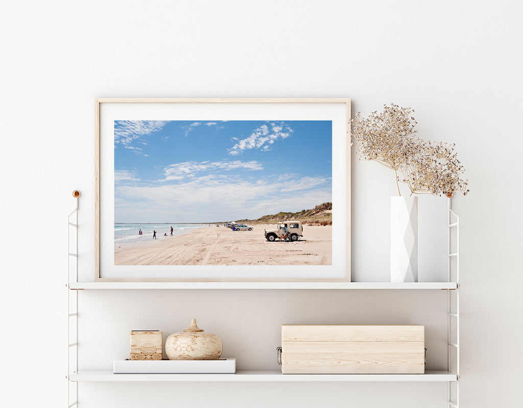 Australian beach art prints. Long Beach Robe print featuring the beach and cars and a land rover parked on the sand, big blue sky and people playing in the water