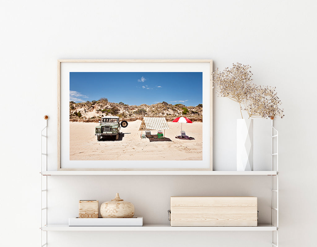 Australian beach wall art featuring a land rover, beach tent and umbrella on the sand at long beach Robe by Millie Brown