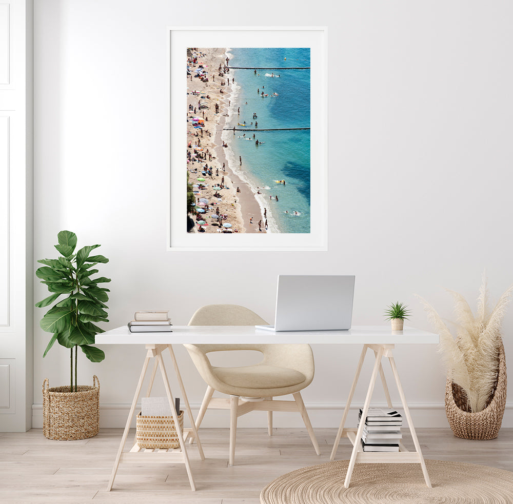 French Riviera beach wall art featuring the beach of Villefranche sur mer on a hot summer day with its colourful beach umbrellas and beach goers enjoying the sea and sun. Fine art prints by photographer Millie Brown