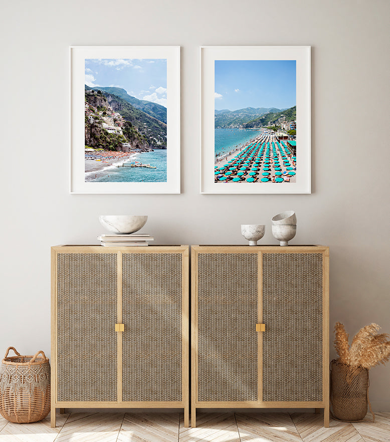 Amalfi coast beach prints featuring the Positano Beach, the village, houses, the cliffs, the orange beach umbrellas and the jetty and blue mediterranean sea by Millie Brown