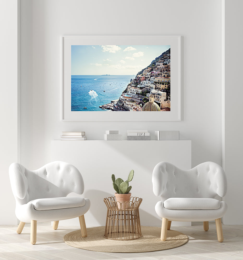 Amalfi coast photographic print featuring the village of Positano and the blue mediterranean water with its small boats moving along the water and shot from above by Millie Brown