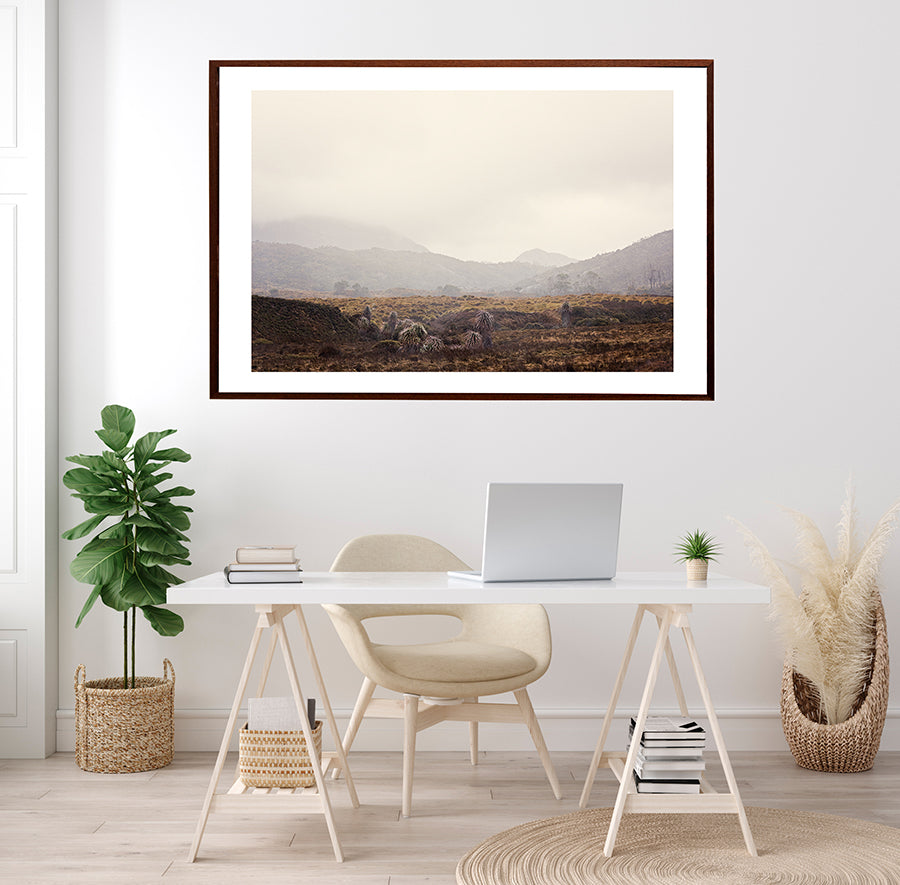 Cradle Mountain photographic wall art print featuring the Tasmanian wilderness in cradle mountain national park. This print is of cradle valley in winter with low cloud and the beautiful landscape of button grass with the mountains in the distance by millie brown