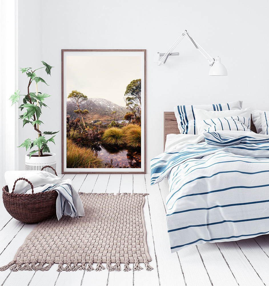 Cradle Mountain wall art photographic print of  Cradle Mountain National Park in Tasmania featuring a beautiful mountain stream surrounded by buttongrass and bushland with dove lake in the background along with snow capped mountains by Photographer Millie Brown