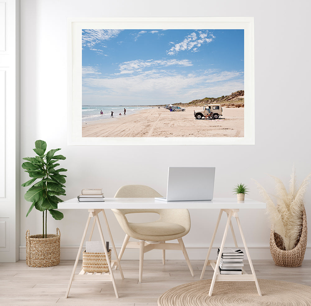 Australian beach wall art featuring long beach robe with its land rovers parked on the sand on a hot summer day fine art print by photographer millie brown