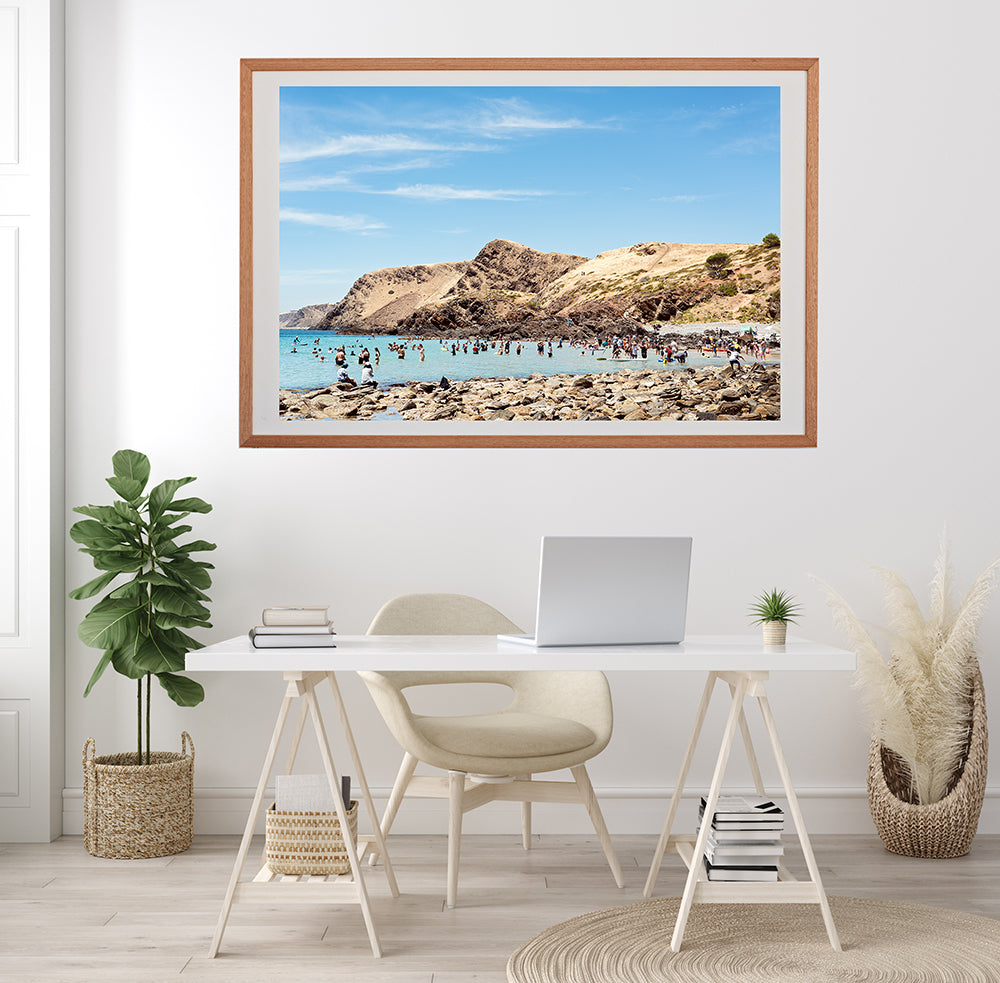 Framed photographic beach wall art print of a south Australian beach Second Valley surrounded by sunburned hills overlooking the blue ocean and beachgoers in the water by professional photographer Millie Brown