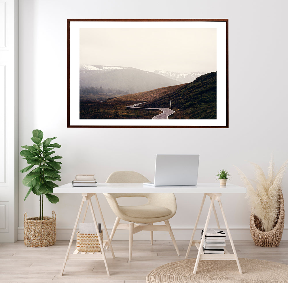 Cradle Mountain fine art prints of the stunning Tasmanian wilderness. This limited edition photographic print features the iconic overland track meandering its way through Cradle Valley and beyond with the snowy mountains in the back ground, by Millie Brown travel Photographer