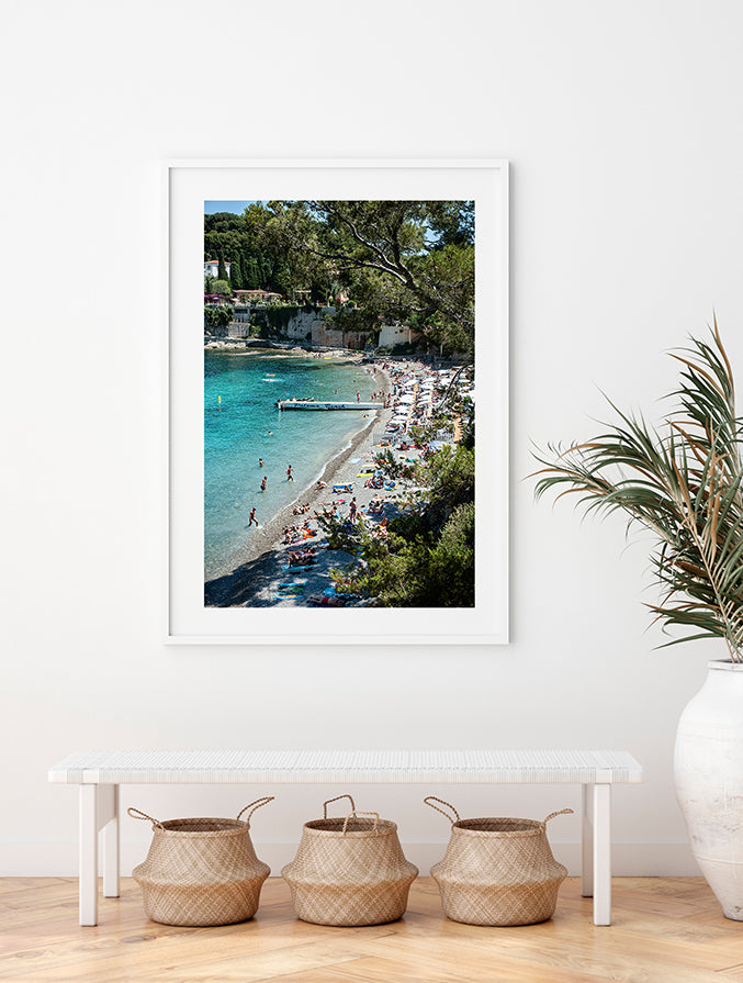 French Riviera wall art featuring Paloma Beach shot from above on a busy hot summer day with beachgoers in the water and relaxing on the private Paloma beach and the public area by Photographer Millie Brown
