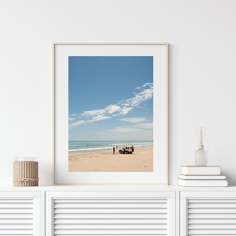 Beach wall art featuring a hot summer day on long beach Robe with a land rover parked on the sand a girl and her dog and swimmers in the blue ocean with a blue sky overheac