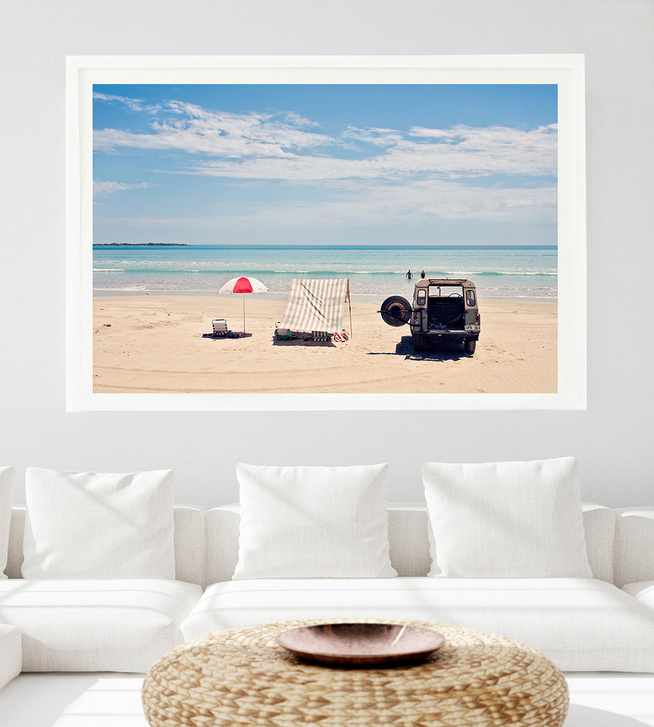 Australian beach wall art featuring Robe Long Beach with its white sand and blue water. A vintage land rover, beach umbrella and tent are in the foreground and two  people in the water in the background
