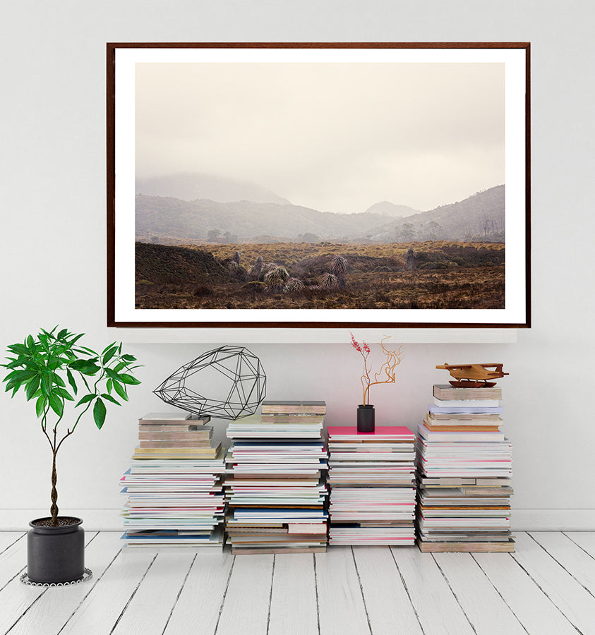Cradle Mountain prints featuring the beauty of the Tasmanian wilderness of Cradle mountain national park in winter with the low cloud over the button grass plains of cradle valley with the snow capped mountains beyond by photographer Millie Brown
